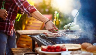 young-men-roasting-barbecue-grill-cottage-countryside